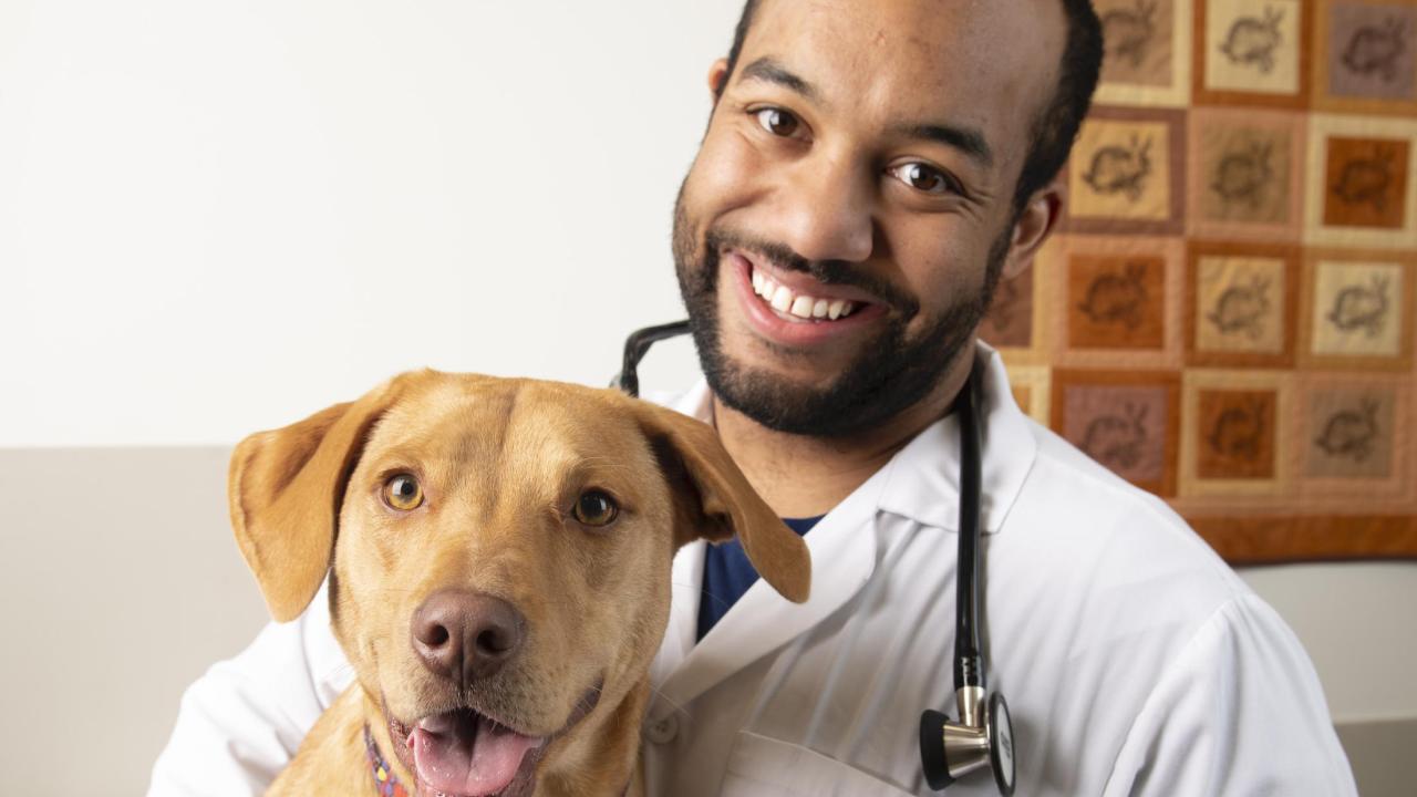 DVM student Sean Gadson has benefitted from the scholarships and student aid offered by UC Davis. Student Sean Gadson with Lucy the dog.