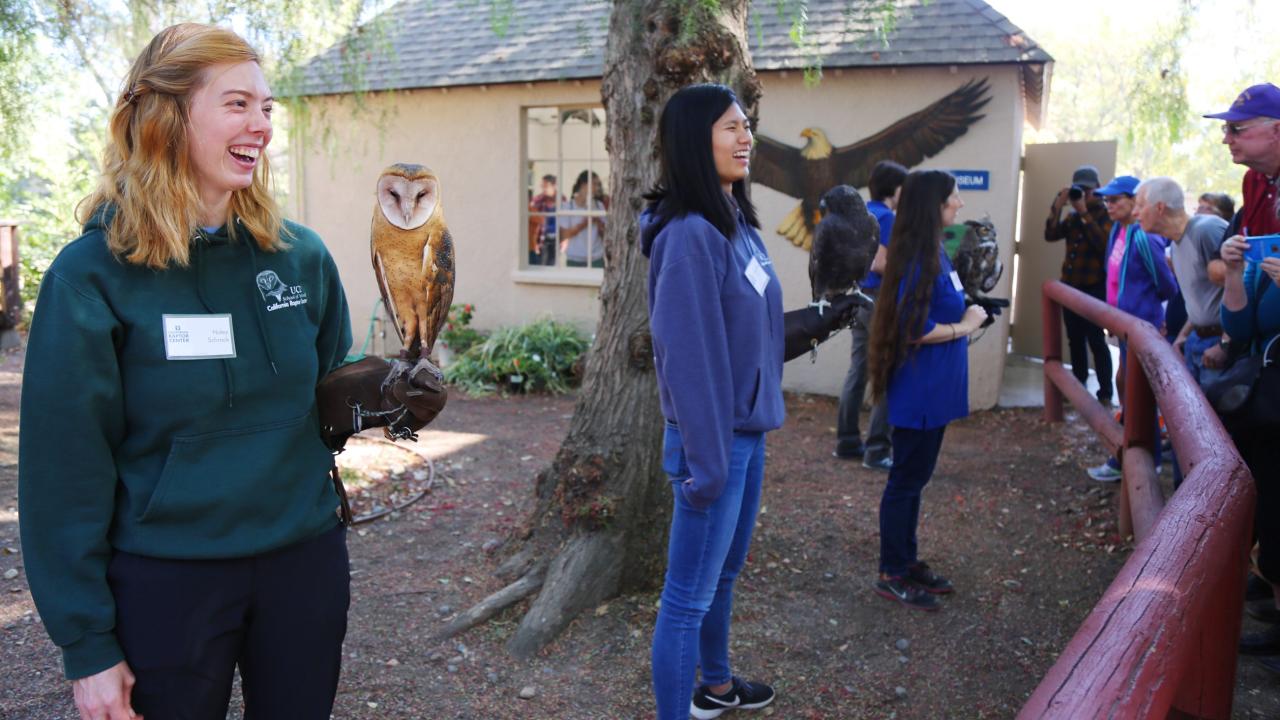 students holding raptors for display