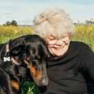 Woman with dog, dog leaning in to her.